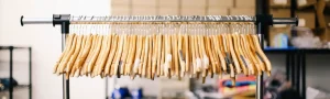 A clothing rack with empty hangers in a retail store.