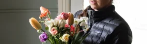 Person holding a bouquet of flowers.