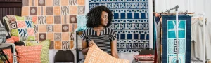 Linda Adimora standing among her products.