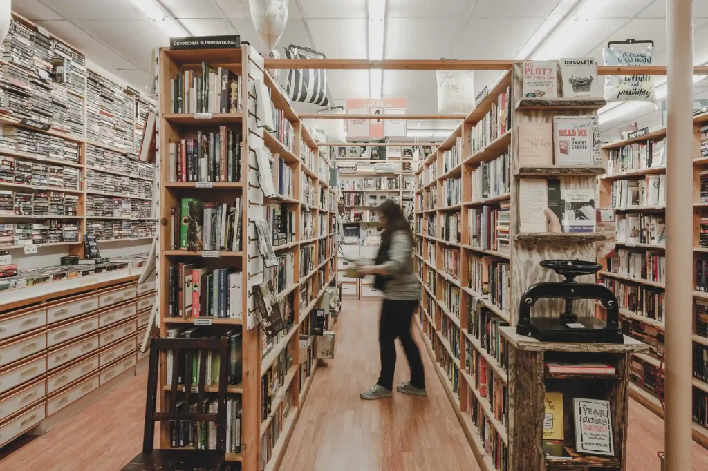 A shopper browses books inside The Book Man bookstore