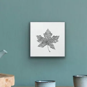 An art print featuring a leaf design hangs on the wall.