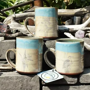A set of three ceramic mugs from gold pan pottery.