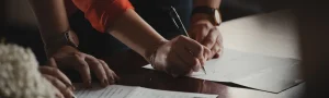 A close up of a hand holding a pen over a document.