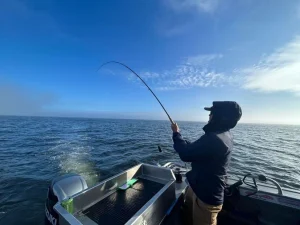 Someone fishing on a Reel Adventures tour with their reel bent as they're trying to catch a fish.